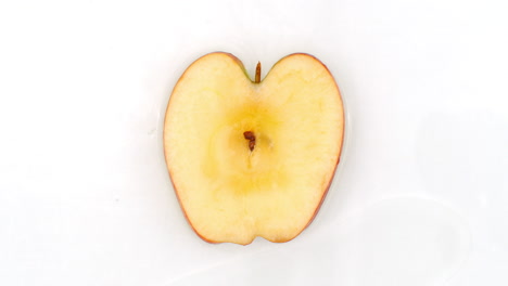 On-a-white-background-sliced-Apple-slices-are-sprinkled-with-water